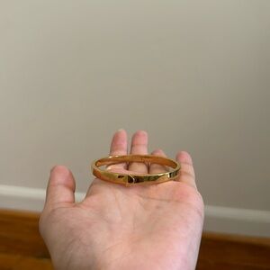 Kate spade gold bangle bracelet with cute little space symbol as the clasp
